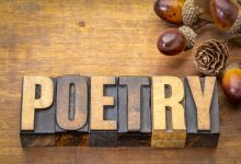 The word "poetry" written in wooden blocks