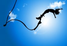 A bungee jumper silhouetted against the sky