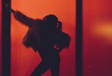 A silhouette of a woman wearing faux fur